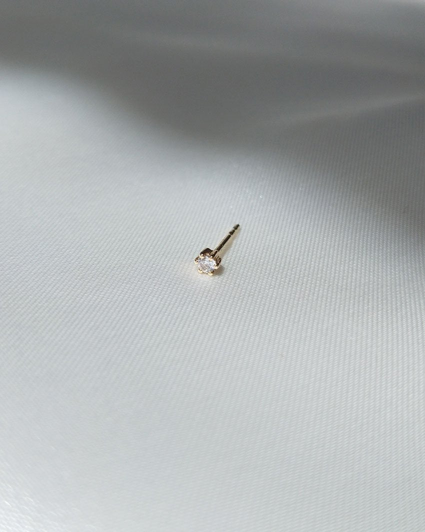 Crystal Droplet Stud (9k Yellow Gold) on a grey silk background by Sit &amp; Wonder